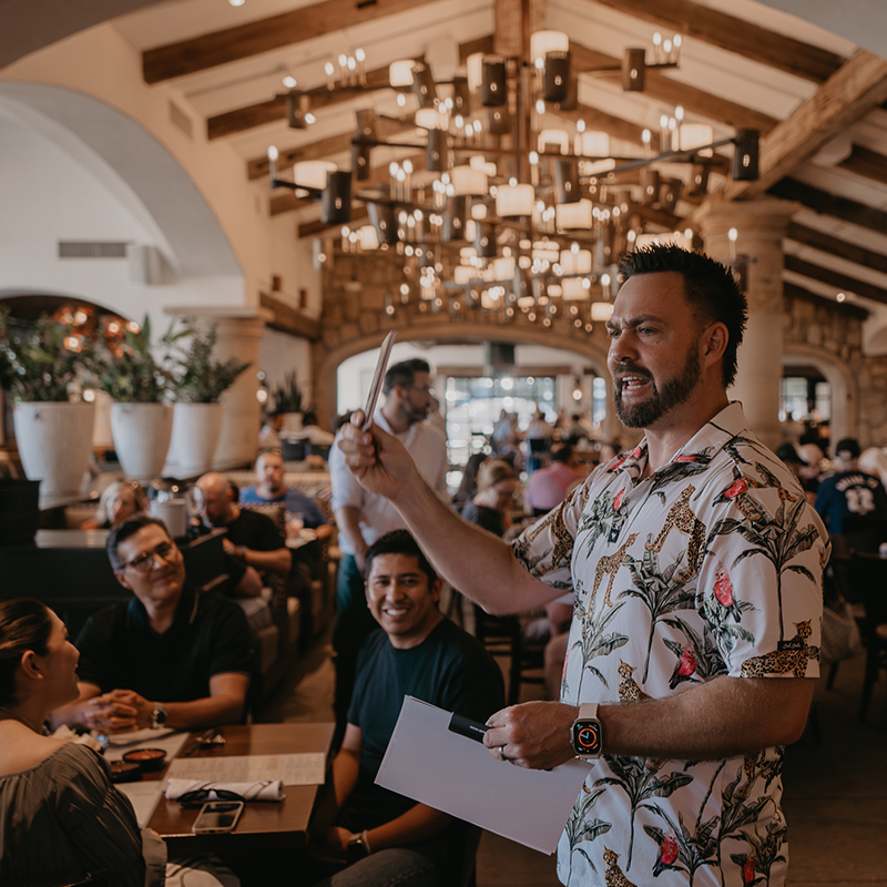 Troy Brave speaking at a Brave Life partners dinner